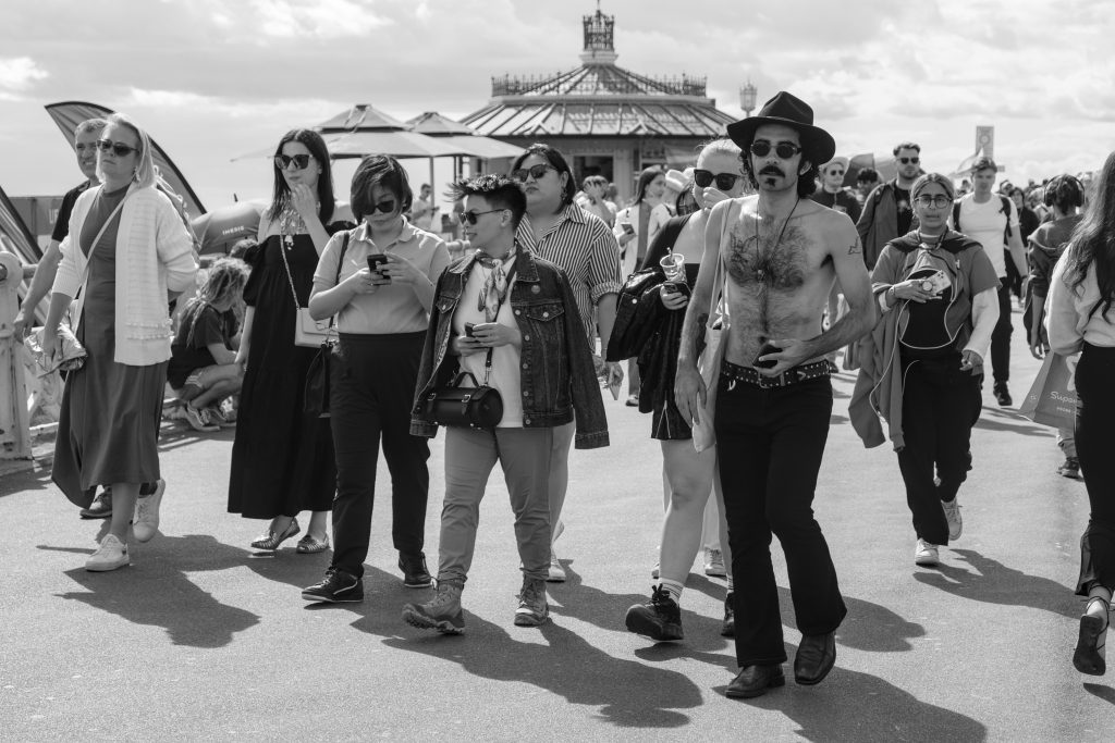 Group of people walking along the seafront.