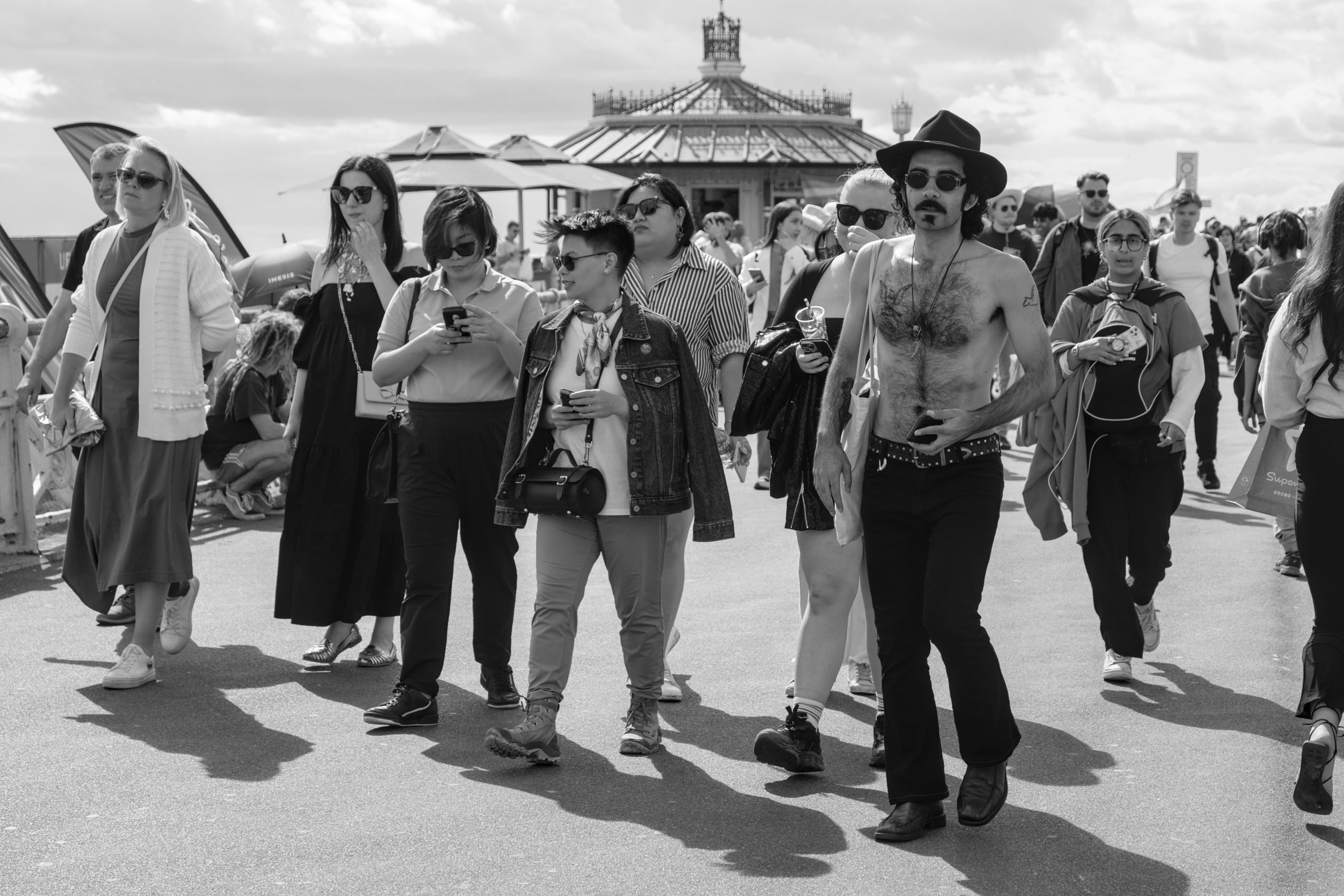 Group of people walking along the seafront.